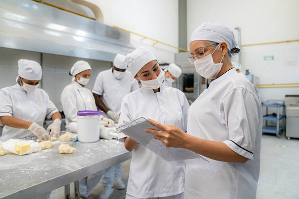 istock Boss giving instructions to a new employee at an industrial bakery 2207852455