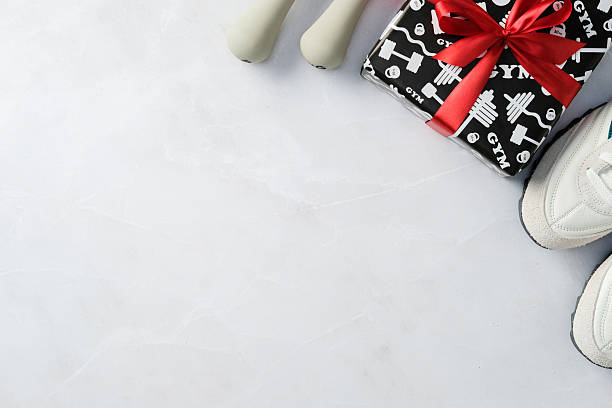 istock Sport gift box, dumbbells, sneakers on marble background. 2207855463