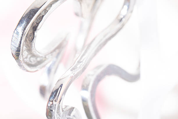 Luxury metal background. Bright and luminous macro shot capturing the reflective beauty of silver decor. Aesthetic blurred background with soft focus in high key