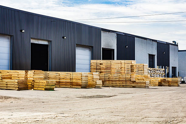 istock Industrial Warehouse With Stack of Wooden Pallets Outdoors on Clear Day 2207857481