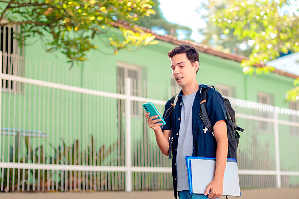 istock Brazilian University Student Using Smartphone Outdoors 2207861773