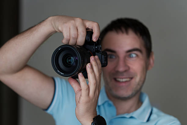 istock Young photographer on blue background 2207863392