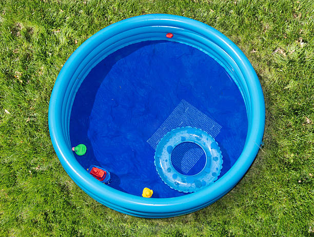 istock The round inflatable pool in the summer garden, top view 2207864991