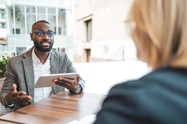 istock Business meeting conversation between colleagues at a modern outdoor setting 2207865062