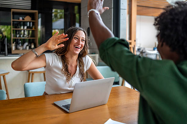 istock Joyful Business Meeting with High Five in Modern Office Setting 2207865076