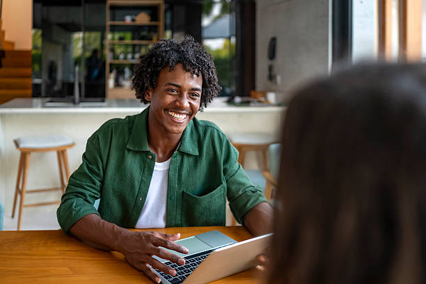 istock Smiling Man Engaged in a Friendly Conversation at Modern Office 2207865085