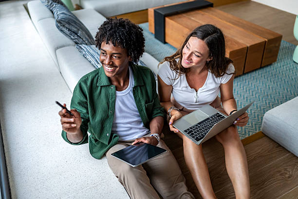 istock Happy Colleagues Collaborating on a Project with Laptop and Tablet 2207865138