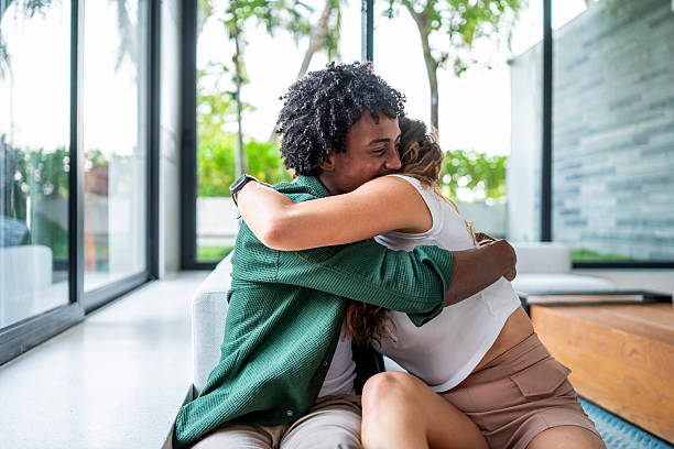 istock Joyful Friends Embracing In A Bright Modern Living Space 2207865156