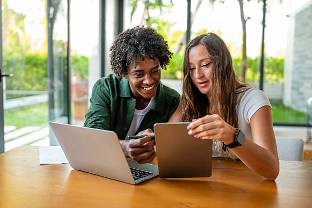 istock Young Professionals Collaborating on a Tablet in a Bright Office 2207865197