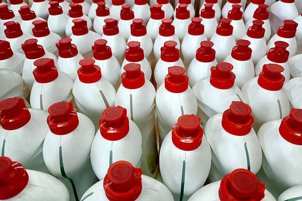 istock Rows of white plastic bottles with red caps 2207871159