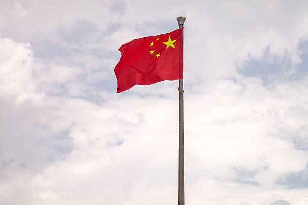 istock view of Chinese flag on sky background. 2207871509