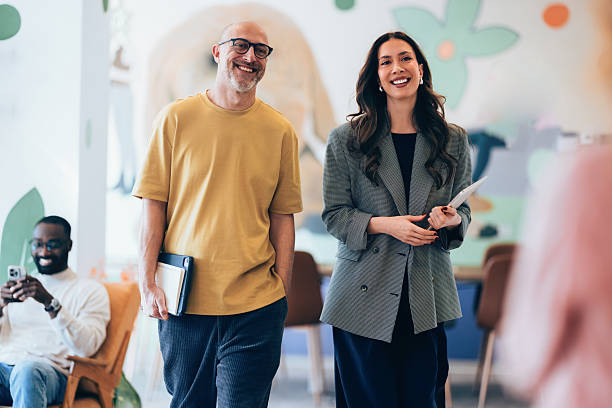 istock Smiling Professionals Walking in a Creative Office Environment Discussing Ideas 2207872226