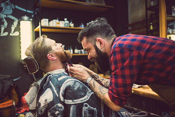 istock Barber Trimming Beard in Vintage Shop: Evening Scene 2207874174