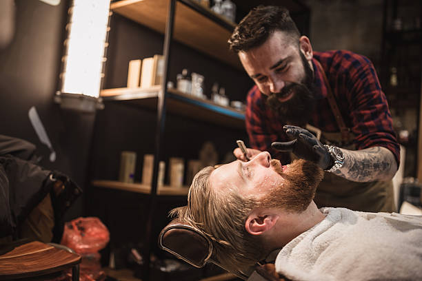 istock Barber Trimming Beard in Modern Barber Shop 2207874187