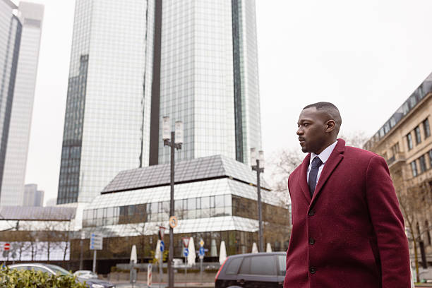 istock Businessman Walking in Urban Setting During Daytime 2207874281