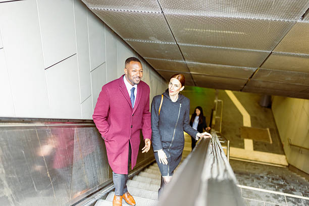 istock Business Colleagues on Escalator in Bright Afternoon 2207874298