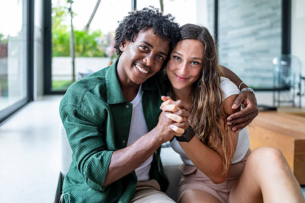 istock Smiling Couple Embracing Happily Inside Modern Bright Living Room 2207874309