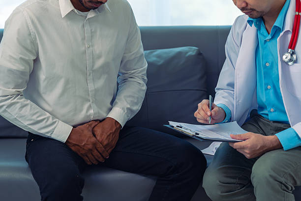 istock Middle-aged man suffering from dysuria, acute gastritis, prostate problems, inflammation, goes to the doctor at the examination table in the hospital. 2207877005
