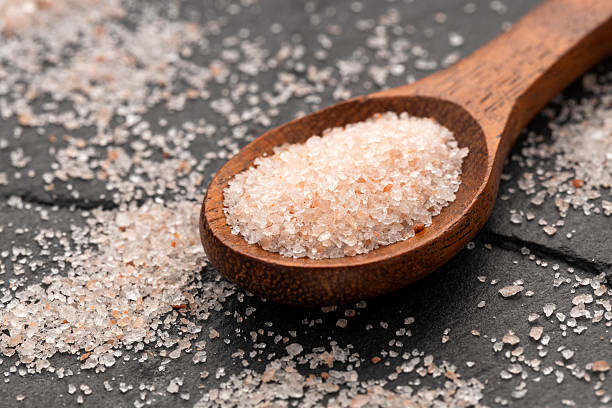 istock Pink Himalayan salt in spoon - Fine crystals sprinkled. 2207878414