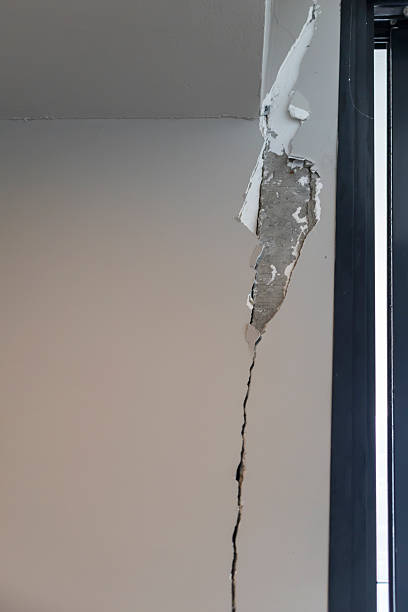 istock Building wall damage and earthquake damage to building structure cracked wall 2207882246