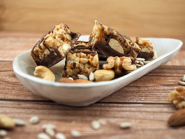 istock Chocolate bar and nuts, Almonds, walnuts, raspberries, Cashew nut, Sunflower seeds 2207883273