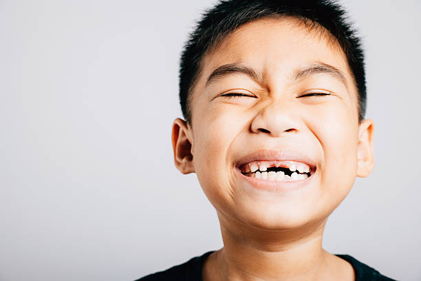 istock Cheerful kid missing upper tooth gap visible. Child dental growth isolated on white. Joyful tooth fairy moment. Children show teeth new gap, dentist problems. little boy no tooth 2207885826
