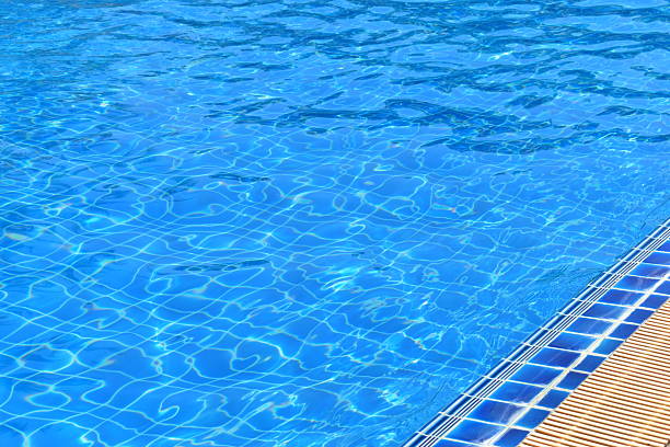 surface of blue swimming pool with water drain
