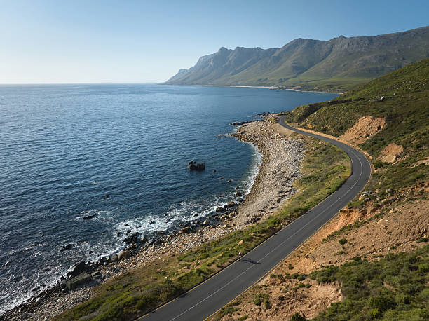 istock Cyclist rides along scenic coastal road overlooking rugged cliffs and ocean views 2207888017