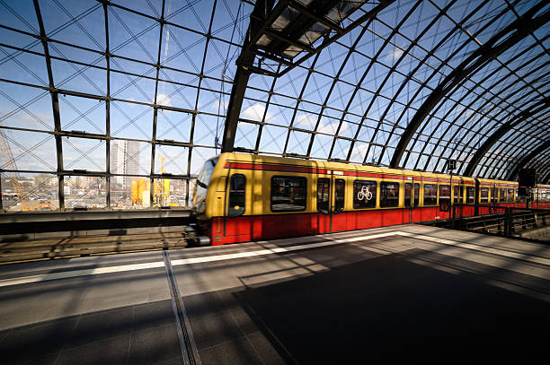 istock Train in Motion at a Modern Glass Train Station 2207890057