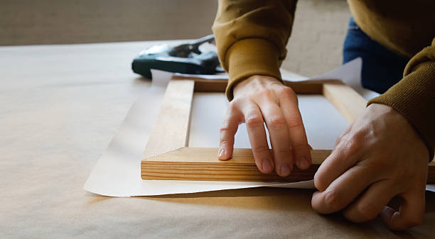 istock Hands stretching canvas on stretcher bars. Gallery wrap. Print on canvas. 2207891145