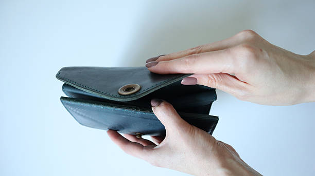 istock Female hands open the wallet, handbag. White background. White hands, light brown nail. Crazy horse leather. Photo. 2207892117