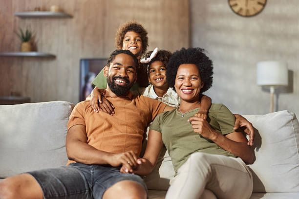 istock Happy black family relaxing on sofa at home. 2207892561