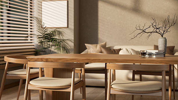 istock Set of a wooden table and armchairs next to window with bright sunlight. Cosy library or study room. 2207895651