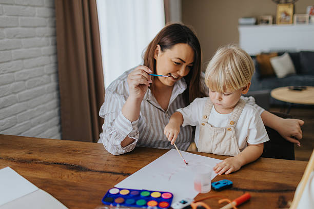 istock Mother and son painting at home 2207895754