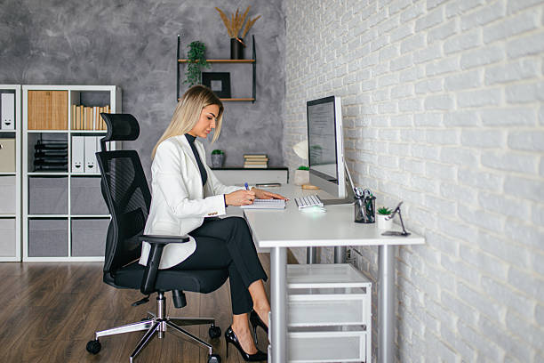 istock Business woman taking notes while working in the office 2207896050