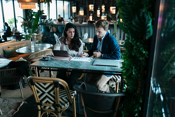istock Business people working on charts in a restaurant 2207899498