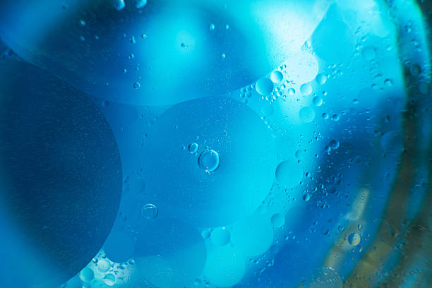istock Oil bubbles close up. circles of water macro. abstract light blue background 2207901202