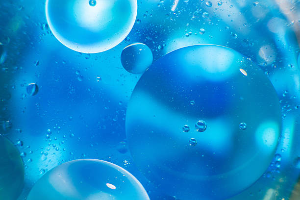 istock Oil bubbles close up. circles of water macro. abstract light blue background 2207901224