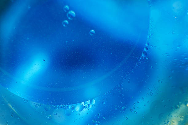 istock Oil bubbles close up. circles of water macro. abstract light blue background 2207901306