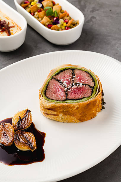 istock Modern plate of Beef Wellington, caramelized shallots and dark sauce 2207902121