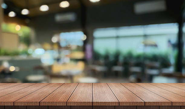istock Empty wooden table top with lights bokeh on blur restaurant background. 2207903519
