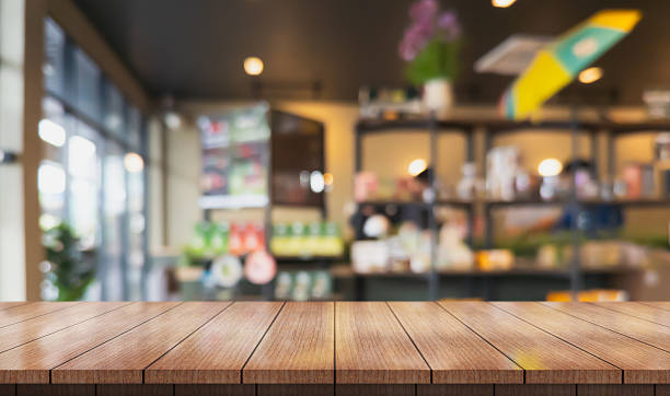 istock Empty wooden table top with lights bokeh on blur restaurant background. 2207903539