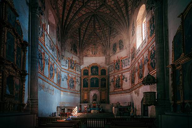Mexico City, Mexico – October 28, 2022: Interior of an ornate historical church with detailed frescoes and vaulted ceilings, illuminated by natural light.