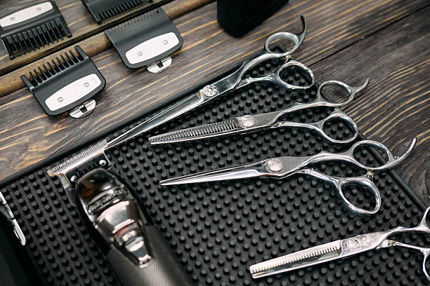 istock Various barber tools are neatly organized for haircutting, showcasing scissors, clippers, and combs ready for use in a bustling barbershop environment 2207906135