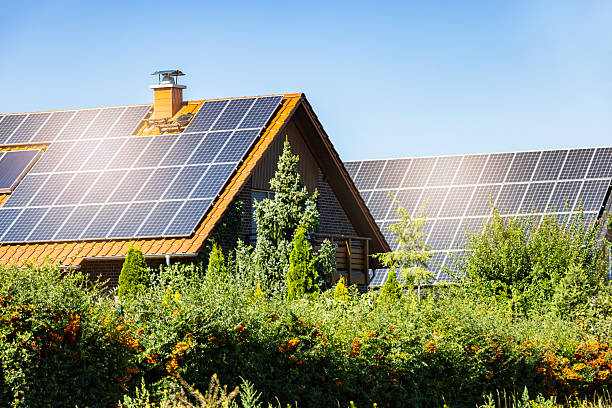 istock Two houses with solar panels on a summer day 2207906249