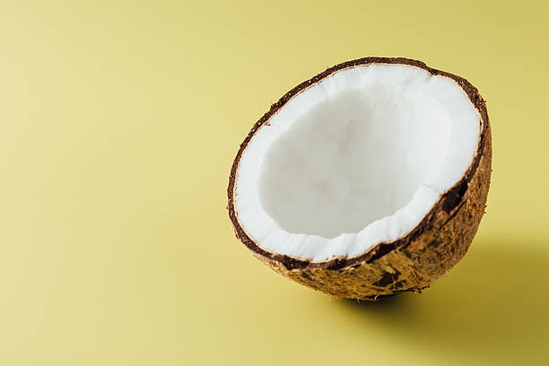istock Fresh Coconut Half on Yellow Background with Smooth Shell and White Edible Flesh 2207911347