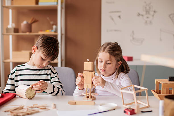 istock Brother and sister attending a woodworking class together 2207911548