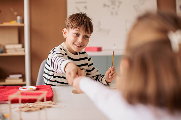 istock Brother and sister attending a woodworking class together 2207911558