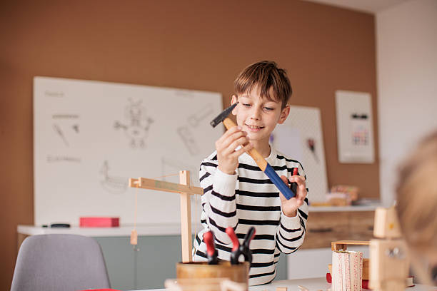Child's hand hitting nail with hammer