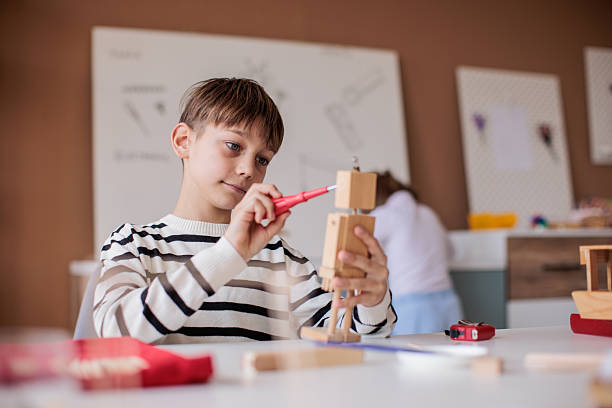 istock Brother and sister working in a woodworking class together 2207911818